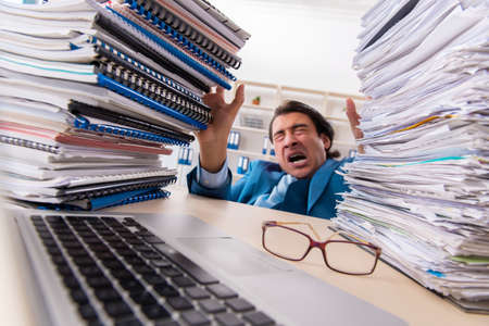 Young handsome businessman unhappy with excessive work