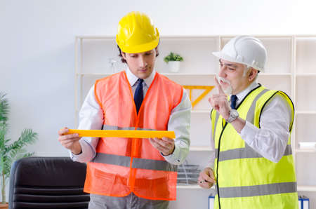 Two engineers colleagues working under project