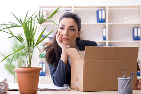 Young female employee being fired from her workの写真素材