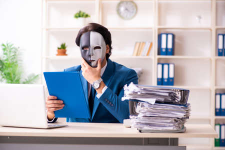 Male employee in the office in industrial espionage conceptの写真素材