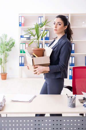 Young female employee being fired from her workの写真素材