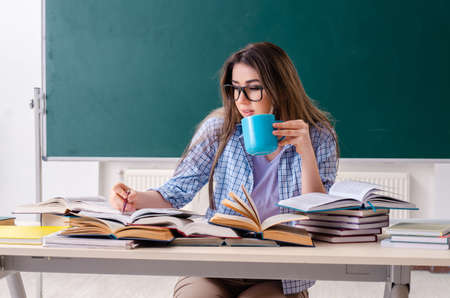 Female student in front of chalkboardの写真素材