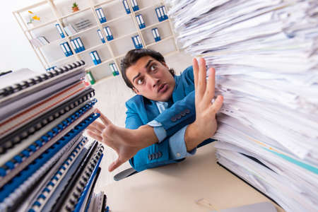 Young handsome businessman unhappy with excessive work