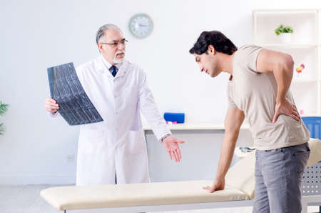Young man visiting old male doctor radiologist