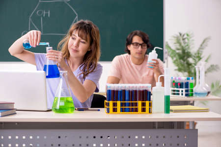 Two chemists students in classroomの写真素材