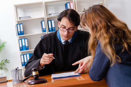 Young woman visiting male lawyerの写真素材