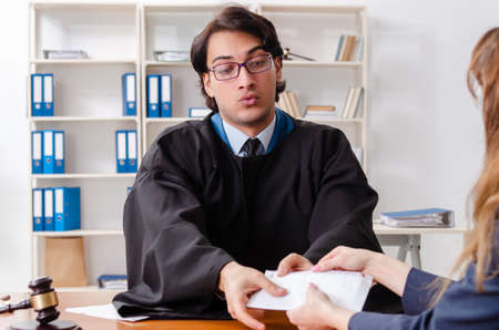 Young woman visiting male lawyerの写真素材
