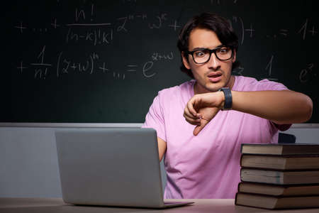 Young male student sitting in classroom