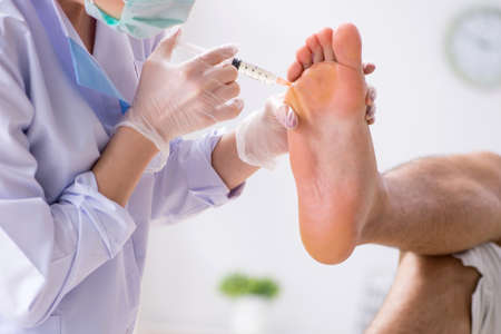Podiatrist treating feet during procedureの写真素材