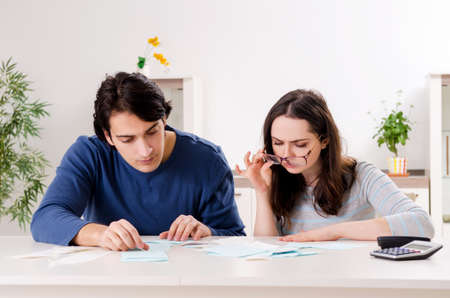 Young couple in budget planning conceptの写真素材