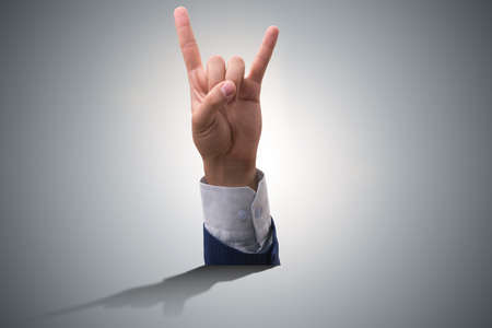 Hands showing victory sign in business conceptの写真素材