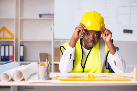 Young black architect working on project