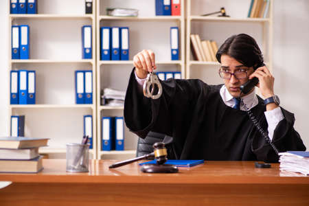 Young handsome judge working in courtの写真素材