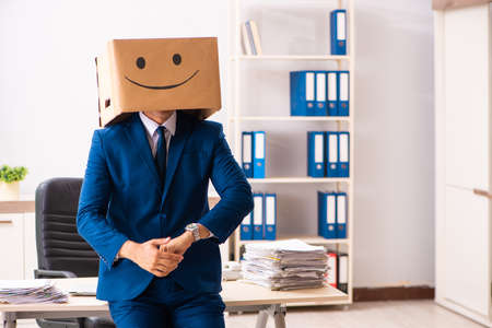 Happy man employee with box instead of his head