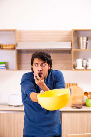 Young man in water leakage from the neighbors conceptの写真素材