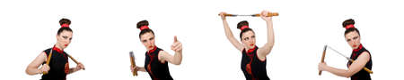 Funny woman with nunchucks isolated on whiteの写真素材