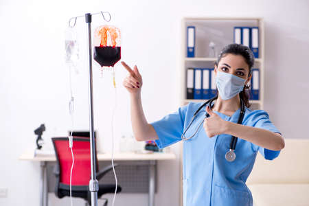 Young female doctor in infusion concept