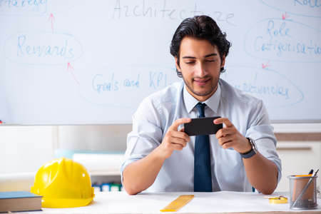 Young male architect in front of the whiteboard