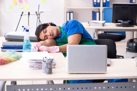 Male handsome professional cleaner working in the officeの写真素材