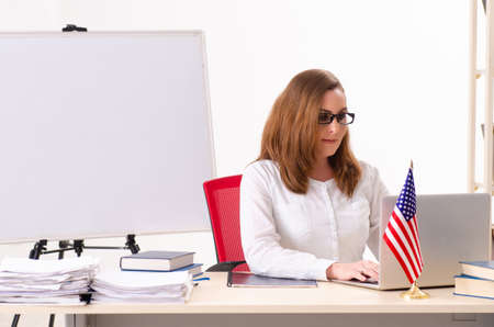Female english language teacher in front of whiteboardの写真素材