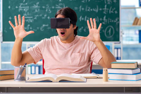 Young male student in the classroomの写真素材