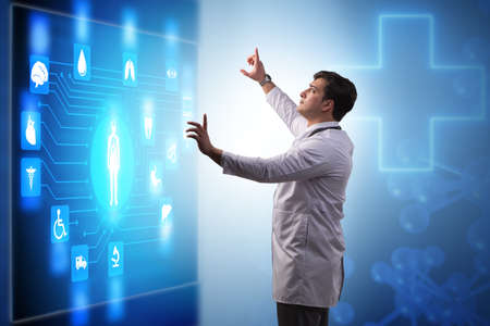 Doctor in telemedicine concept looking at screenの写真素材