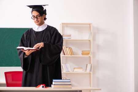 Graduate student in front of green board