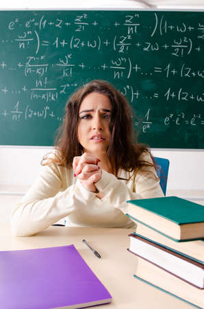 Young female math teacher in front of chalkboardの写真素材