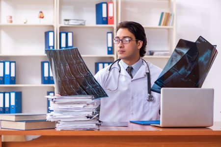 Young handsome doctor working in the clinicの写真素材