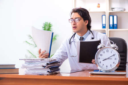 Young handsome doctor working in the clinicの写真素材