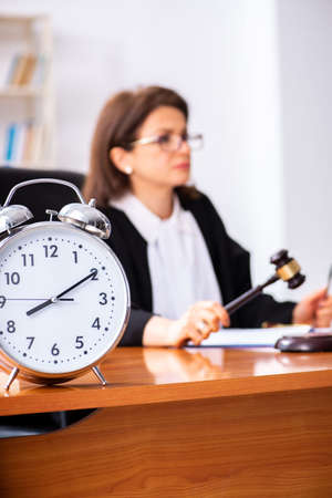 Middle-aged female doctor working in courthouse