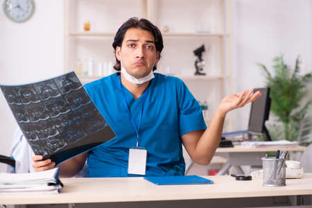 Young handsome doctor radiologist working in the clinic