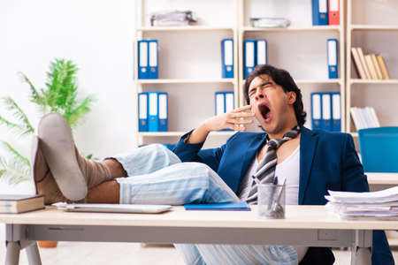 Employee coming to work straight from bedの写真素材