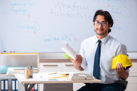 Young male architect in front of the whiteboardの写真素材
