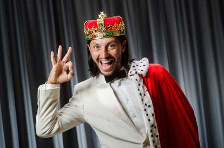 Funny king wearing crown in coronation conceptの写真素材