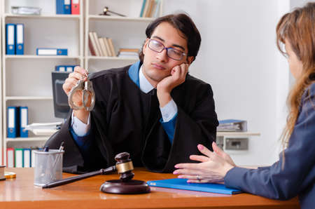 Young woman visiting male lawyerの写真素材