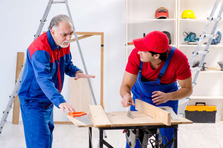 Two professional contractors laying flooring at home