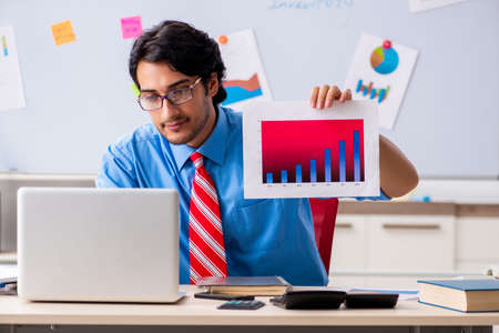 Young male financial manager working in the officeの写真素材