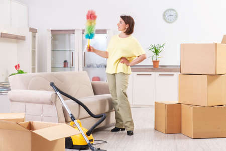 Middle-aged woman cleaning new apartmentの写真素材