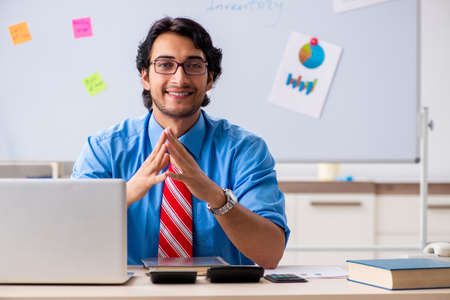 Young male financial manager working in the officeの写真素材