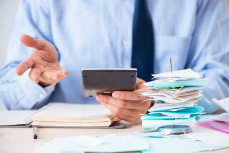 Young handsome businessman in budget planning concept