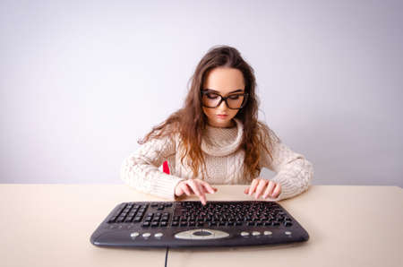 Funny nerd girl working on computer