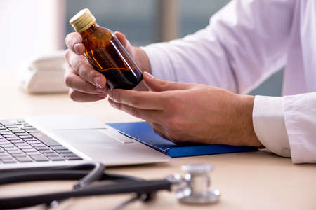 Young male doctor in telemedicine conceptの写真素材