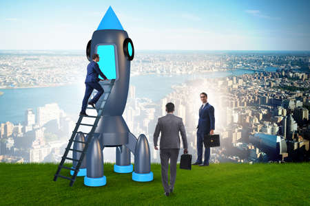 Young businessman boarding space rocket in start-up conceptの写真素材