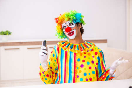Male clown preparing for perfomance at homeの写真素材