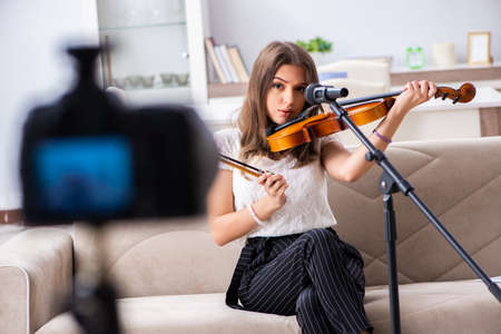 Female beautiful blogger playing violinの写真素材