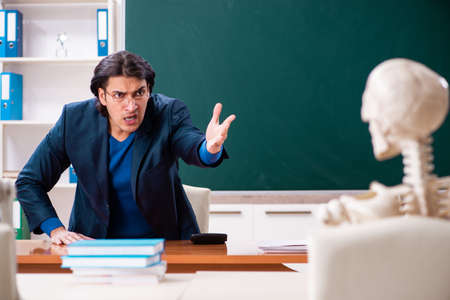 Male teacher and skeleton student in the classroomの写真素材