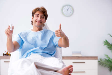 Young male patient lying on couch in hospitalの写真素材