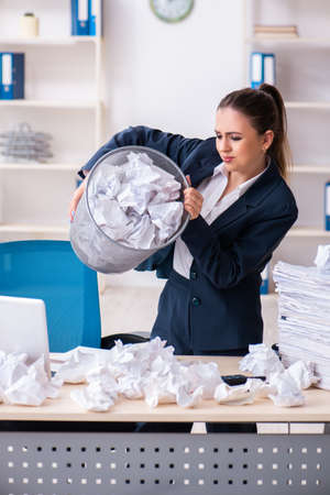 Businesswoman rejecting new ideas with lots of papersの写真素材