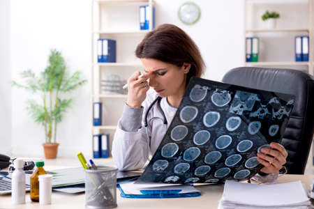 Aged female doctor working in the clinicの写真素材